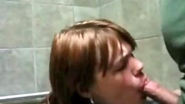 Naughty redhead sucks cock in public toilet