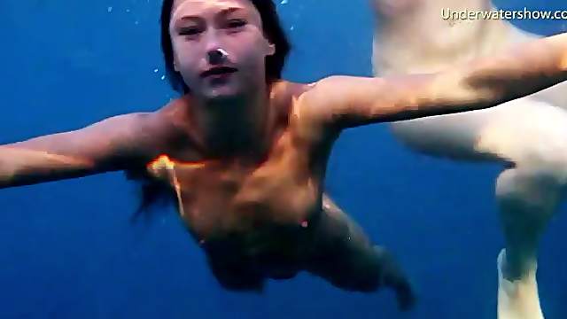 See lean naked bodies underwater in ocean