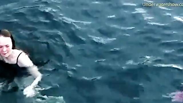 Group of girls swims naked in the ocean