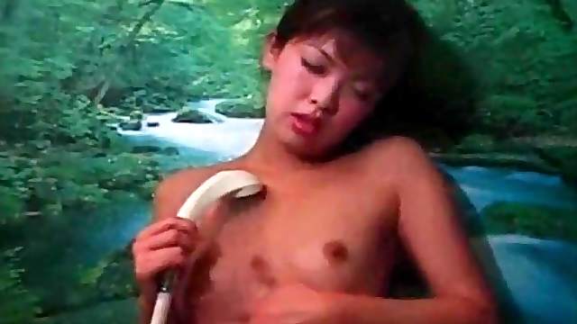 Skinny Asian cutie masturbates in the shower