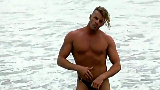 Muscular hunk from the beach sucks his cock