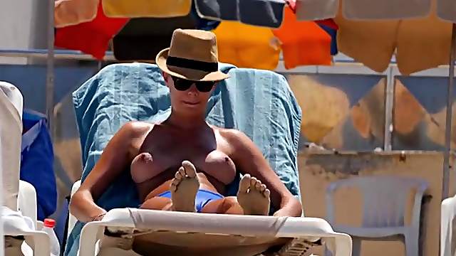 Hot blonde on the beach has perfect big tits