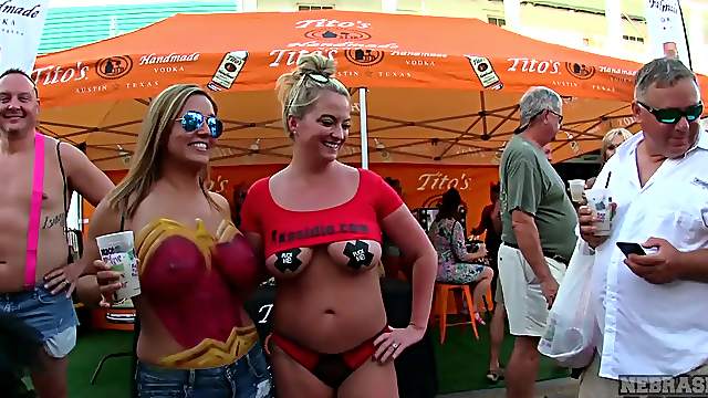 Body painted beauties playing at a street fair